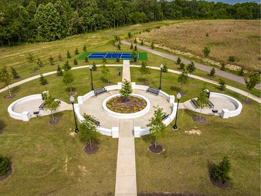 A park with a circular walkway and benches.