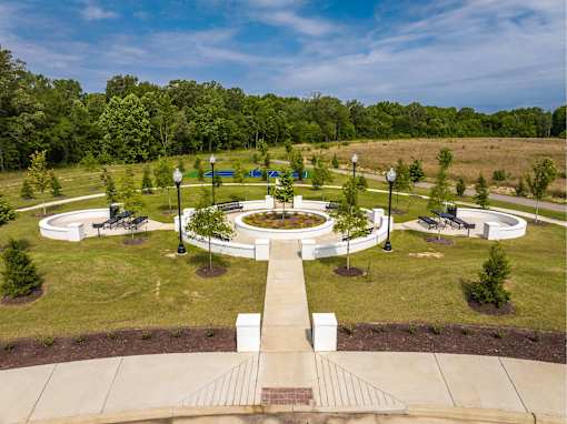 A park with a circular walkway and benches.