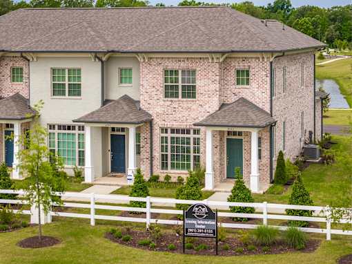 A house with a sign in front of it that says "Landing Information".