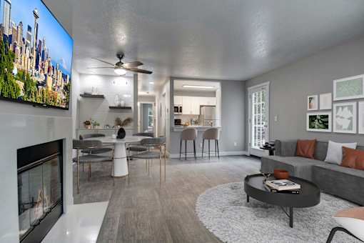 A modern living room with a fireplace and a television on the wall.