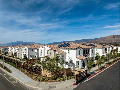 A row of houses with a mountain in the background.