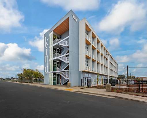 A modern building with the word "kind" written on it.