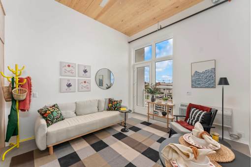 A living room with a white couch and a checkered floor.