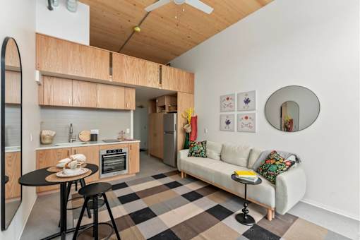 A kitchen with a table and a couch.