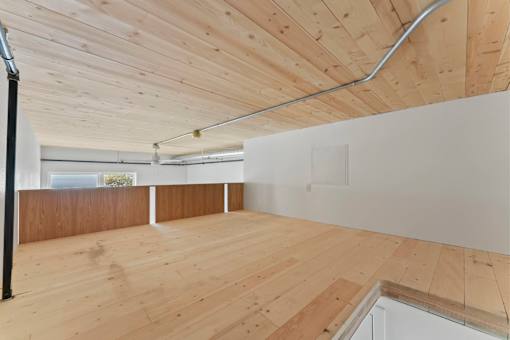 A room with wooden floors and a white wall.