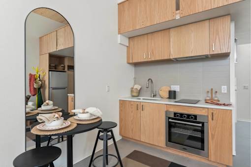 A kitchen with wooden cabinets and a black countertop.