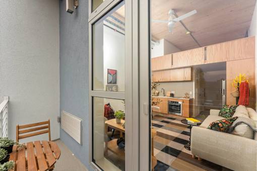 A living room with a couch, a table, and a chair.