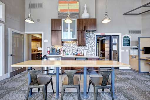 A kitchen with a table and chairs in the middle of the room.