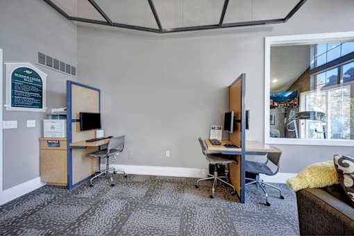 A room with two desks and chairs.