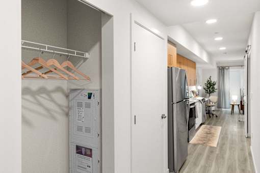 A modern kitchen with a refrigerator and a white wall.