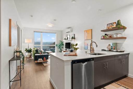 A modern kitchen with a large island and stainless steel appliances.