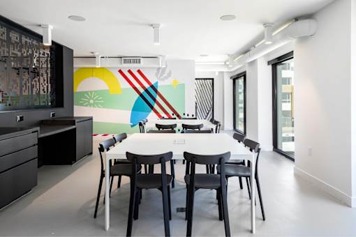 A dining room with a white table and chairs