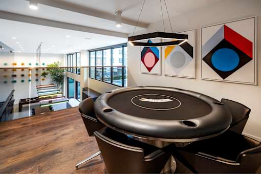 A black table with a white logo in the middle is in the foreground of the image.