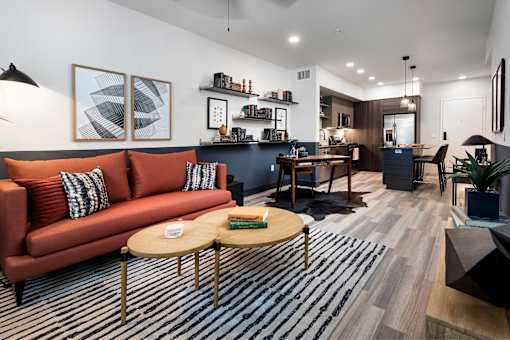A living room with a red couch and a coffee table.