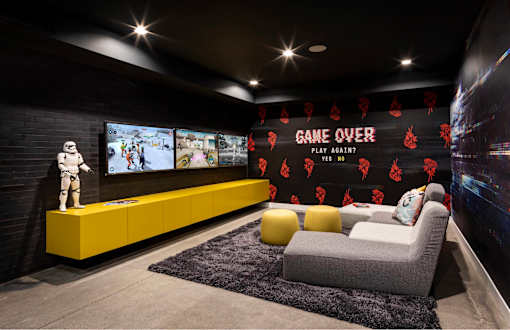 A Star Wars themed room with a large screen and a Stormtrooper figurine