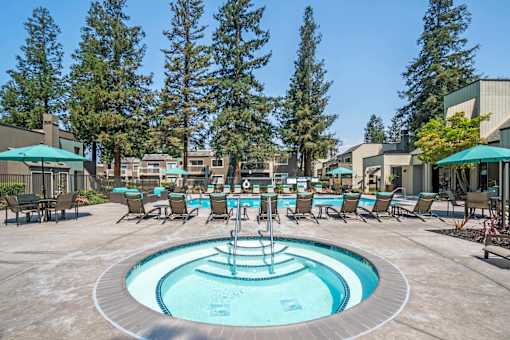 A pool with a fountain in the middle of it.
