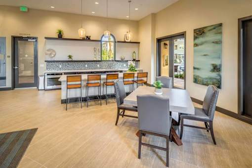 A dining room with a long table and chairs.