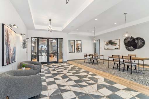 A black and white checkered floor in a room with a dining table and chairs.