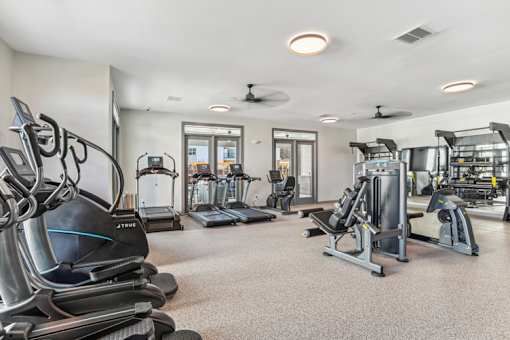 A spacious gym with treadmills, elliptical machines, and other exercise equipment.