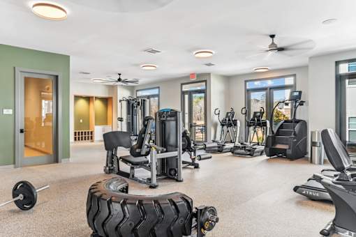 A spacious gym with a variety of equipment including treadmills, weights, and exercise machines.