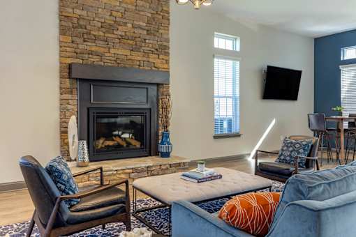 A living room with a fireplace and a blue couch.