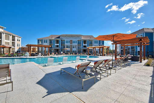 A pool area with sun loungers