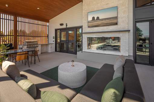 A living room with a couch, a table, and a painting on the wall.