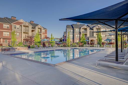 A swimming pool surrounded by apartment buildings.