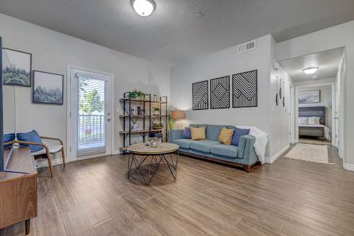 A living room with a blue couch and a wooden coffee table.