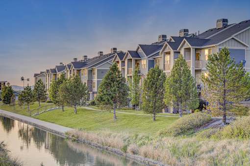 A row of houses with a body of water in front.