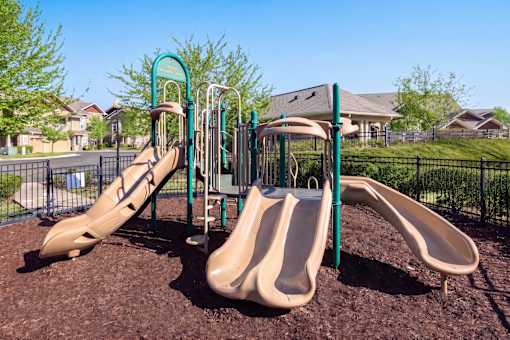 A playground with a slide and a swing set.