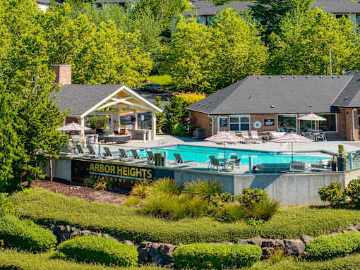 A pool area with a sign that says Arbor Heights.