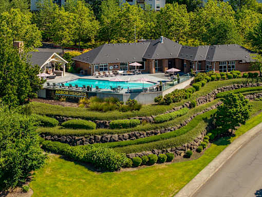 A resort with a pool and a sign that says Arbor Heights.