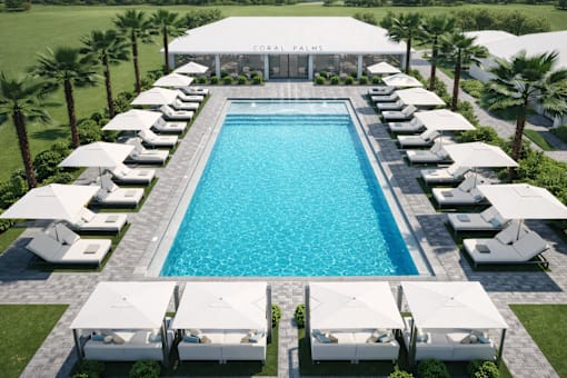 A large pool surrounded by sun loungers and umbrellas.