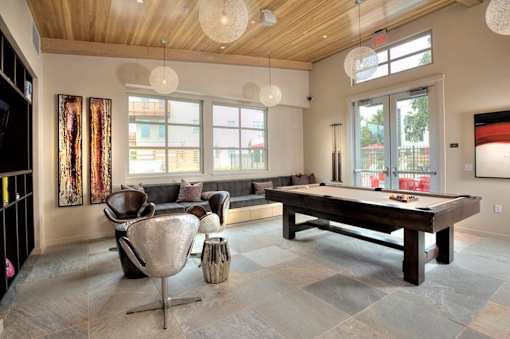 A room with a pool table and a chair.