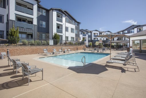Pool on sunny day with lounge chairs