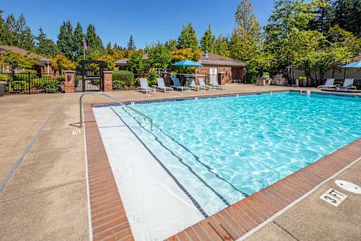 A swimming pool with a brick edge and a white inner lining.