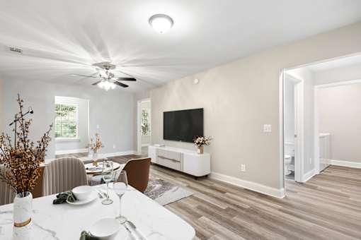 A modern dining room with a white table and chairs.