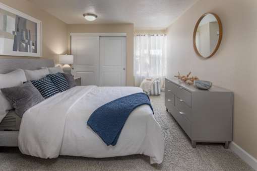 a bedroom with a large bed and a dresser