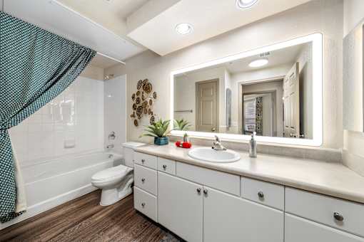 A bathroom with a white sink and a white toilet.