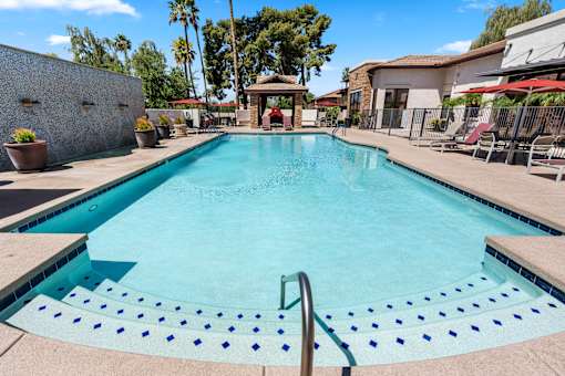 A swimming pool with a metal ladder in the middle.