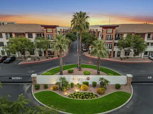 A beautifully landscaped entrance to a Forte 2 apartment complex.