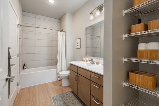 A bathroom with a white tub, toilet, and sink.