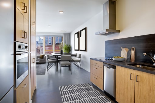 Kitchen and dining area with a table and chairs and a large window