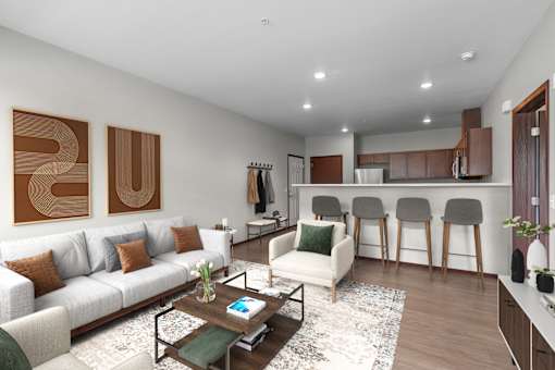 A modern living room with a white sofa, a coffee table, and a kitchen area in the background.