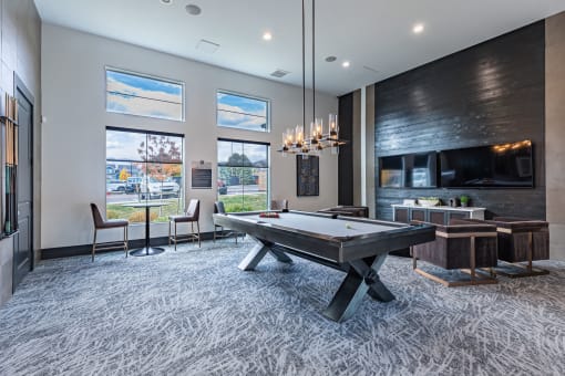 a game room with a pool table and a tv