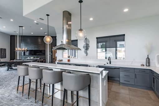 a large kitchen with an island and bar stools