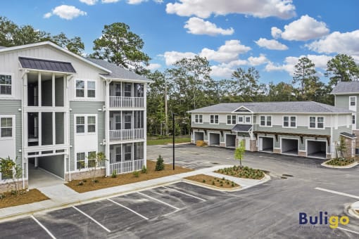 an empty parking lot in front of several apartment buildings