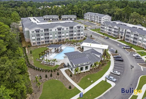 an aerial view of an apartment complex with a swimming pool