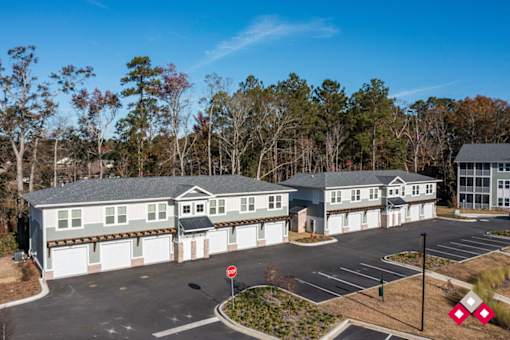 A large building with a parking lot in front of it.